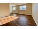 Bright living room with wood floors, natural light from large windows, and neutral wall color at 1243 Gaylord St # 302, Denver, CO 80206