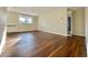 Open living room with beautiful hardwood floors and ample natural light with an open doorway at 1243 Gaylord St # 302, Denver, CO 80206