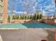 A covered outdoor pool surrounded by a brick wall and trimmed evergreen bushes at 1243 Gaylord St # 302, Denver, CO 80206