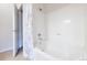 Well-lit and clean bathroom featuring a tub with tile surround and shower at 3100 Blue Sky Cir # 205, Erie, CO 80516