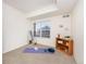 Bright bedroom featuring neutral carpet, built-in shelving, and a sunny window at 3100 Blue Sky Cir # 205, Erie, CO 80516