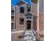 Exterior shot of the building entrance with stone facade and well-kept landscaping at 3100 Blue Sky Cir # 205, Erie, CO 80516