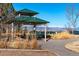 Green Gazebo with picnic tables overlooking the mountains in a beautiful outdoor space at 3100 Blue Sky Cir # 205, Erie, CO 80516