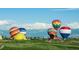 View of colorful hot air balloons against a scenic backdrop of mountains and clear blue skies at 3100 Blue Sky Cir # 205, Erie, CO 80516