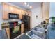 Modern kitchen features stainless steel sink, sleek countertops, warm cabinets, and black appliances at 3100 Blue Sky Cir # 205, Erie, CO 80516