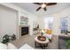 Cozy living room with a fireplace, neutral paint, large window and a ceiling fan, perfect for a comfortable living at 3100 Blue Sky Cir # 205, Erie, CO 80516