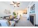 Inviting living room with a ceiling fan, fireplace and an open layout to the kitchen at 3100 Blue Sky Cir # 205, Erie, CO 80516