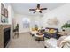 Comfortable living room with neutral walls, soft carpeting, a ceiling fan, and a modern electric fireplace at 3100 Blue Sky Cir # 205, Erie, CO 80516