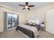 Bright main bedroom features a ceiling fan, sliding door access to a private balcony, and ample natural light at 3100 Blue Sky Cir # 205, Erie, CO 80516