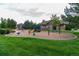 Community playground and gathering spaces in a large common grass area at 3100 Blue Sky Cir # 205, Erie, CO 80516