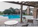 Inviting community pool with lounge chairs, poolside tables, and pergola for relaxing summer days at 3100 Blue Sky Cir # 205, Erie, CO 80516