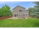 Expansive backyard featuring a lush lawn, patio area, and secure wooden fencing at 3860 Mallard Dr, Highlands Ranch, CO 80126
