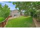 Spacious backyard with lush green lawn, privacy fence, mature trees and sliding glass door to patio at 3860 Mallard Dr, Highlands Ranch, CO 80126