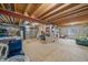 Unfinished basement offering storage space with exposed wood beams and a sturdy metal support beam at 3860 Mallard Dr, Highlands Ranch, CO 80126