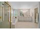 Bright bathroom with dual sinks, a tub, and a glass-enclosed shower at 3860 Mallard Dr, Highlands Ranch, CO 80126