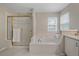 Bright bathroom with a large tub and a glass-enclosed shower at 3860 Mallard Dr, Highlands Ranch, CO 80126