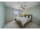 Cozy bedroom with a ceiling fan, large window, and a comfortable bed with decorative pillows at 3860 Mallard Dr, Highlands Ranch, CO 80126
