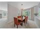 Bright dining room featuring a modern chandelier, stylish seating, and a view of the outdoors at 3860 Mallard Dr, Highlands Ranch, CO 80126