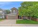 Charming two-story home with a well-manicured lawn, mature trees and a brick and siding facade at 3860 Mallard Dr, Highlands Ranch, CO 80126