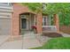 Welcoming front porch with brick columns and a seating area, perfect for enjoying the outdoors at 3860 Mallard Dr, Highlands Ranch, CO 80126