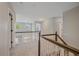 Second-floor hallway with decorative railings, neutral carpeting, and well-lit access to rooms at 3860 Mallard Dr, Highlands Ranch, CO 80126