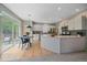 Bright kitchen with quartz countertops, stainless steel appliances, and a cozy breakfast nook with backyard access at 3860 Mallard Dr, Highlands Ranch, CO 80126