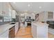 Open kitchen layout with modern appliances and quartz counters, connected to dining and living spaces at 3860 Mallard Dr, Highlands Ranch, CO 80126