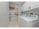 Efficient laundry room with a washer, a dryer, and storage cabinets at 3860 Mallard Dr, Highlands Ranch, CO 80126