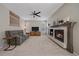 Inviting living room with a cozy fireplace, ceiling fan, and comfortable seating, creating a relaxing atmosphere at 3860 Mallard Dr, Highlands Ranch, CO 80126