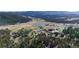 An aerial view showcasing a community, lake, and school at 6857 Timbers Drive, Evergreen, CO 80439