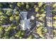 Aerial view showcases a home, driveway, and forest at 6857 Timbers Drive, Evergreen, CO 80439