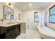 Luxurious bathroom with a freestanding tub, marble accents, and modern vanity at 6857 Timbers Drive, Evergreen, CO 80439