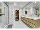 Bright bathroom with a modern vanity, glass shower, and tiled floor at 6857 Timbers Drive, Evergreen, CO 80439