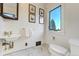 Quaint powder room featuring classic fixtures, marble floors and bright window at 6857 Timbers Drive, Evergreen, CO 80439