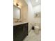 This powder room features marble floors, modern black vanity and gold fixtures at 6857 Timbers Drive, Evergreen, CO 80439