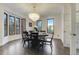 Dining room with hardwood floors, modern chandelier, and a bay window providing ample natural light at 6857 Timbers Drive, Evergreen, CO 80439