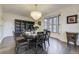 Elegant dining room with a chandelier, hardwood floors, and a bay window letting in natural light at 6857 Timbers Drive, Evergreen, CO 80439