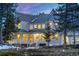 Stunning two-story home featuring a welcoming front porch and beautiful architectural details at 6857 Timbers Drive, Evergreen, CO 80439