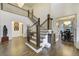 Elegant foyer with soaring ceilings, hardwood floors, staircase, and access to dining room at 6857 Timbers Drive, Evergreen, CO 80439