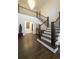Bright foyer with hardwood floors, staircase with iron railing, and elegant decor at 6857 Timbers Drive, Evergreen, CO 80439