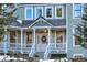 Charming entrance with decorative wreath, sidelights, and classic architectural details at 6857 Timbers Drive, Evergreen, CO 80439