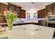 Kitchen island with quartz countertops, stainless steel appliances, and stylish decorative elements at 6857 Timbers Drive, Evergreen, CO 80439