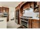 Modern kitchen with stainless steel appliances and dark wood cabinetry at 6857 Timbers Drive, Evergreen, CO 80439