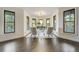 Bright living room featuring hardwood floors, large windows, and modern decor at 6857 Timbers Drive, Evergreen, CO 80439
