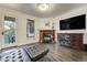 Living area with fireplace, television, hardwood floors, and outdoor access at 6857 Timbers Drive, Evergreen, CO 80439