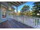 Charming porch with wood floors overlooks a forest at 6857 Timbers Drive, Evergreen, CO 80439