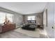 Staged bedroom with hardwood floors, neutral colored walls, with a view of the windows at 13890 E Marina Dr # 107, Aurora, CO 80014