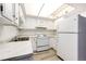 White kitchen features updated appliances at 13890 E Marina Dr # 107, Aurora, CO 80014