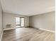 Spacious unfurnished living room with hardwood floors, and a sliding glass door leading to outdoor area at 13890 E Marina Dr # 107, Aurora, CO 80014