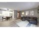 Living room with neutral walls, modern flooring, a sectional sofa, and an adjacent dining area and kitchen at 13890 E Marina Dr # 107, Aurora, CO 80014